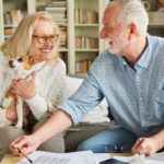 April 25 Events Page Image - Shorehaven Elderly man and woman smiling and holding small dog