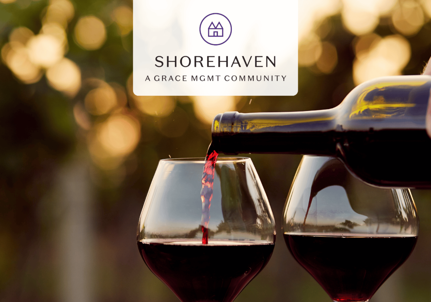 Wine being poured into two glasses with a blurred sunset background and a Shorehaven logo overlay saying 'Shorehaven: A Grace Mgmt Community'